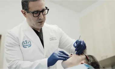 Oral surgeon helping a patient who has dental anxiety with dental sedation options.
